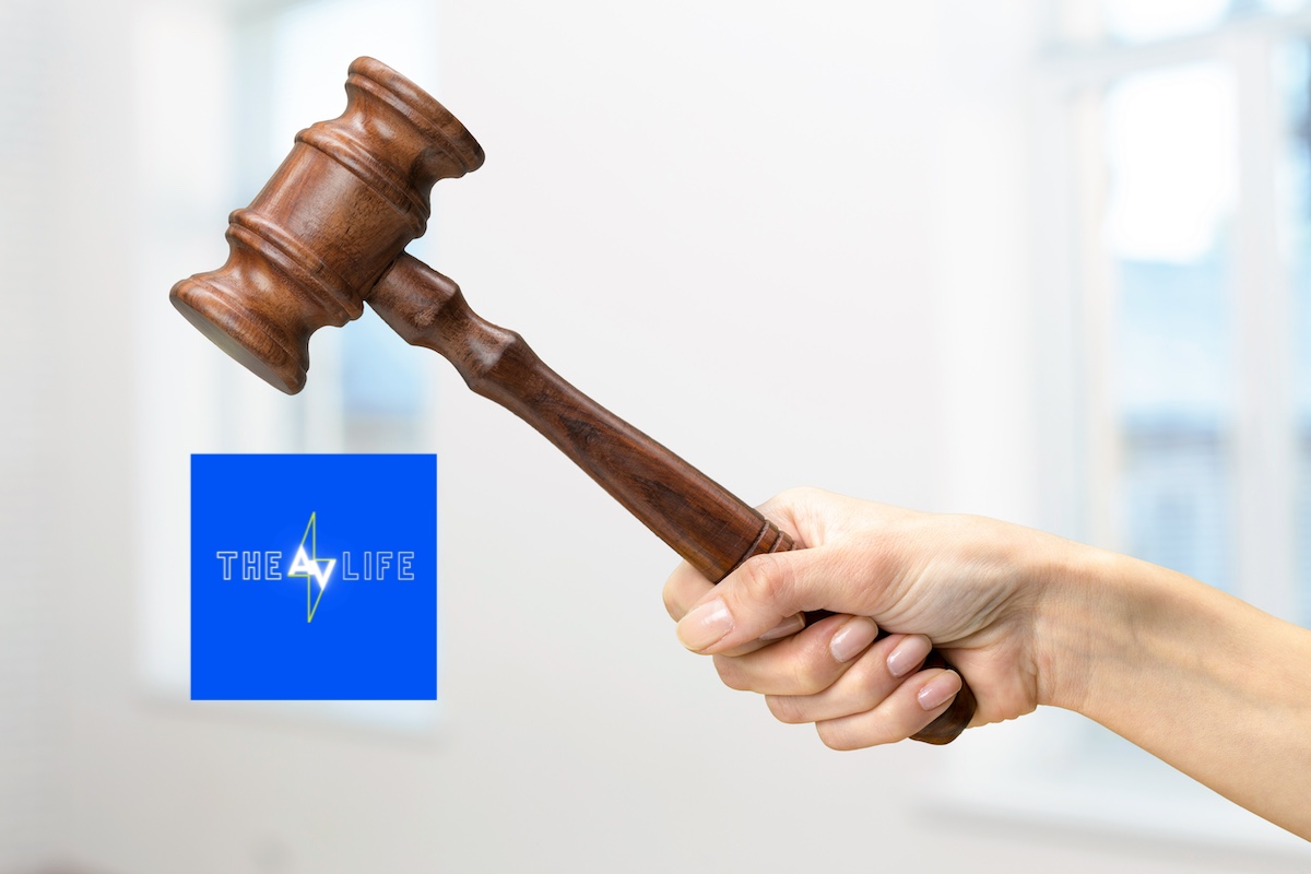 someones-hand-holding-wooden-law-gavel-2023-11-27-05-18-40-utc