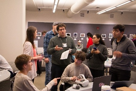 One student standing above others discussing