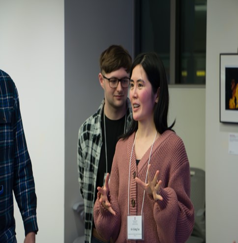 Women explaining things to group.