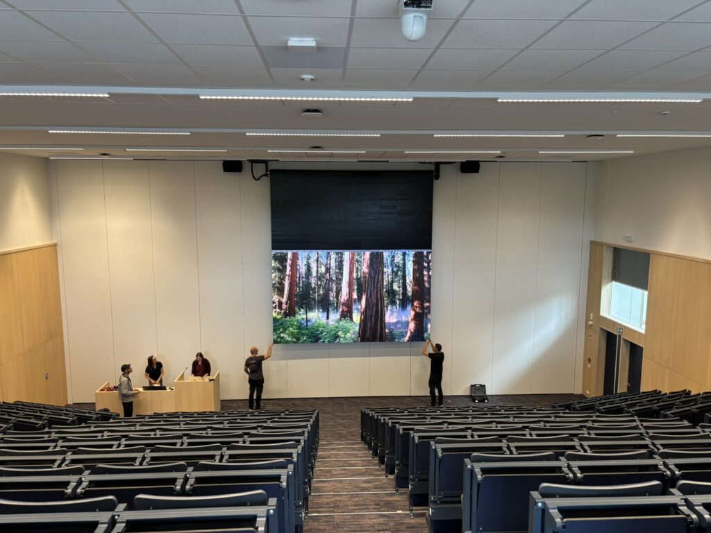Large lecture space with projector screen.