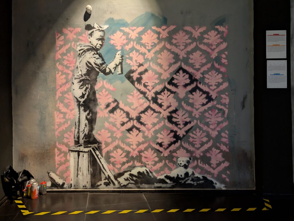 Banksy Art of a girl painting over a swastika