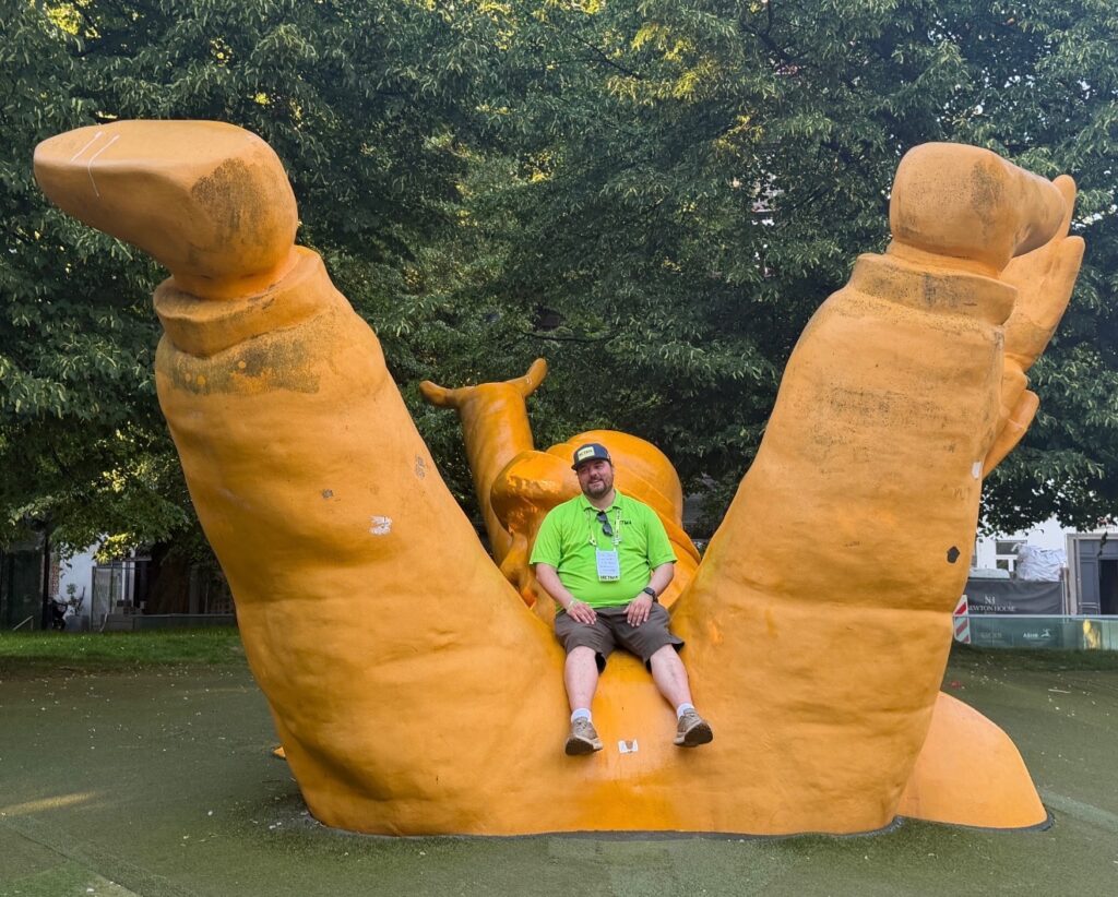 Troy sitting on a statute