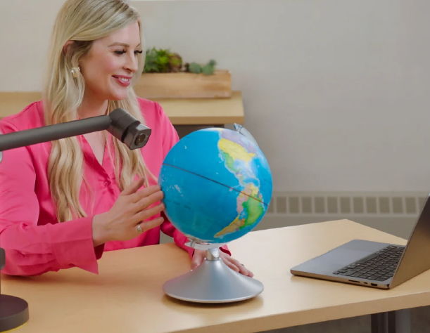 Reach looking at a globe
